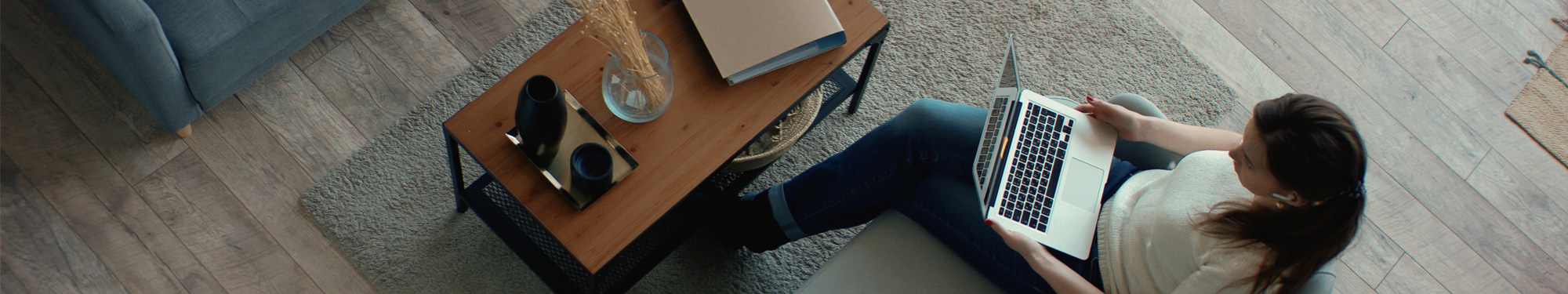 woman sitting on a couch on her laptop