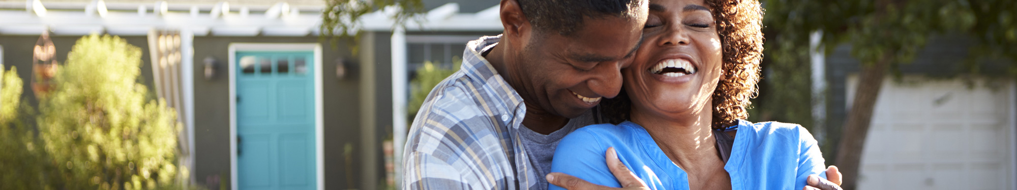 man and woman laughing and holding onto each other