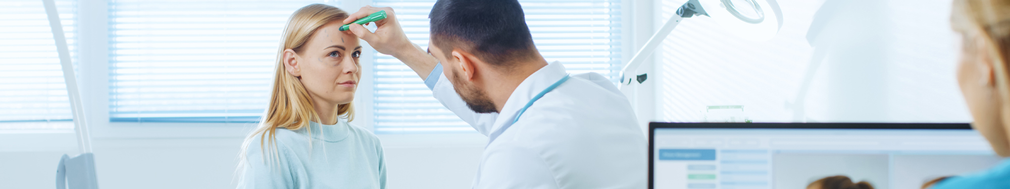 doctor making cosmetic procedure lines on a patient