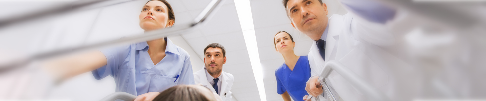 doctors and nurses pushing a patient bed