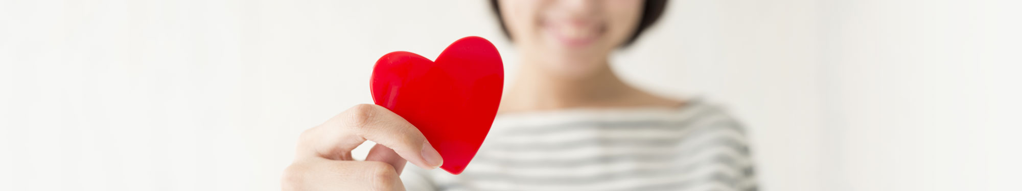 girl holding a red heart